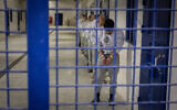 Israel Prisons Service officers prepare inmates for release as part of a hostage deal at Ketziot Prison in southern Israel, on February 26, 2025. (Chaim Goldberg/Flash90)