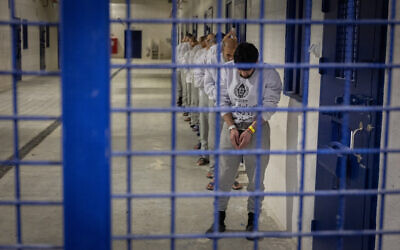 Israel Prisons Service officers prepare inmates for release as part of a hostage deal at Ketziot Prison in southern Israel, on February 26, 2025. (Chaim Goldberg/Flash90)
