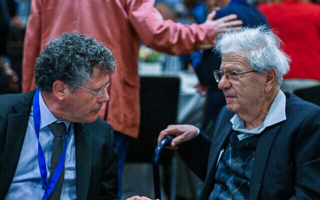 Supreme Court President Isaac Amit (left) speaks with Aharon Barak during a conference of the Israeli Association of Public Law (IAPL) in Haifa, December 4, 2025. (Flash90)