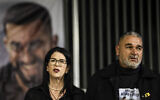 Talik Gvili (left) and her husband Itzik stand in front of a poster of their hostage son Ran during a rally for his return in his hometown of Meitar in southern Israel on December 6, 2025. (Tsafrir Abayov/Flash90)