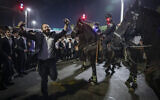Ultra-Orthodox men block Route 4 during a protest against the jailing of yeshiva students who failed to comply with an IDF draft order, Bnei Brak, December 8, 2025. (David Cohen/Flash90)