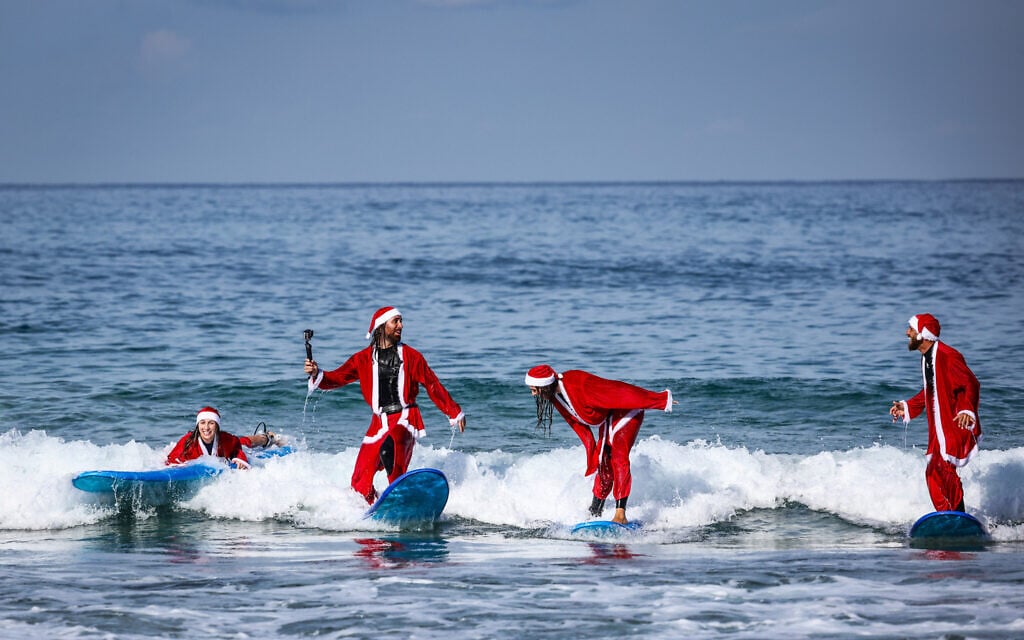 Israelis dressed as Santa Claus at the beach in Tel Aviv ahead of the Christmas holiday, December 2, 2025. (Jamal Awad/Flash90) Israelis dressed as Santa Claus at the beach in Tel Aviv ahead of the Christmas holiday, December 2, 2025. (Jamal Awad/Flash90)