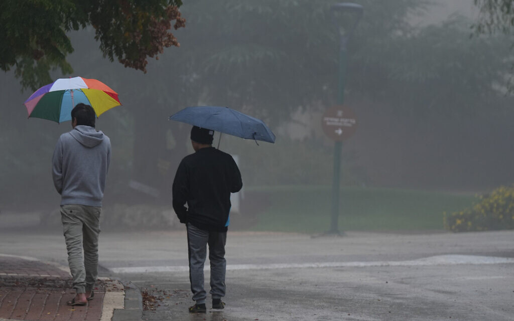 People walk on a foggy, rainy day in Kibbutz Malkia, near the border with Lebanon, on December 10, 2025. (Ayal Margolin/Flash90) People walk on a foggy, rainy day in Kibbutz Malkia, near the border with Lebanon, on December 10, 2025. (Ayal Margolin/Flash90)