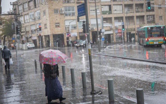 People walk along flooded streets in Jerusalem, as storm Byron hits Israel, December 11, 2025. (Chaim Goldberg/FLASH90) People walk along flooded streets in Jerusalem, as storm Byron hits Israel, December 11, 2025. (Chaim Goldberg/FLASH90)
