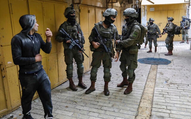 Illustrative: Israeli security forces stand guard in the West Bank city of Hebron, December 13, 2025. (Wisam Hashlamoun/Flash90)