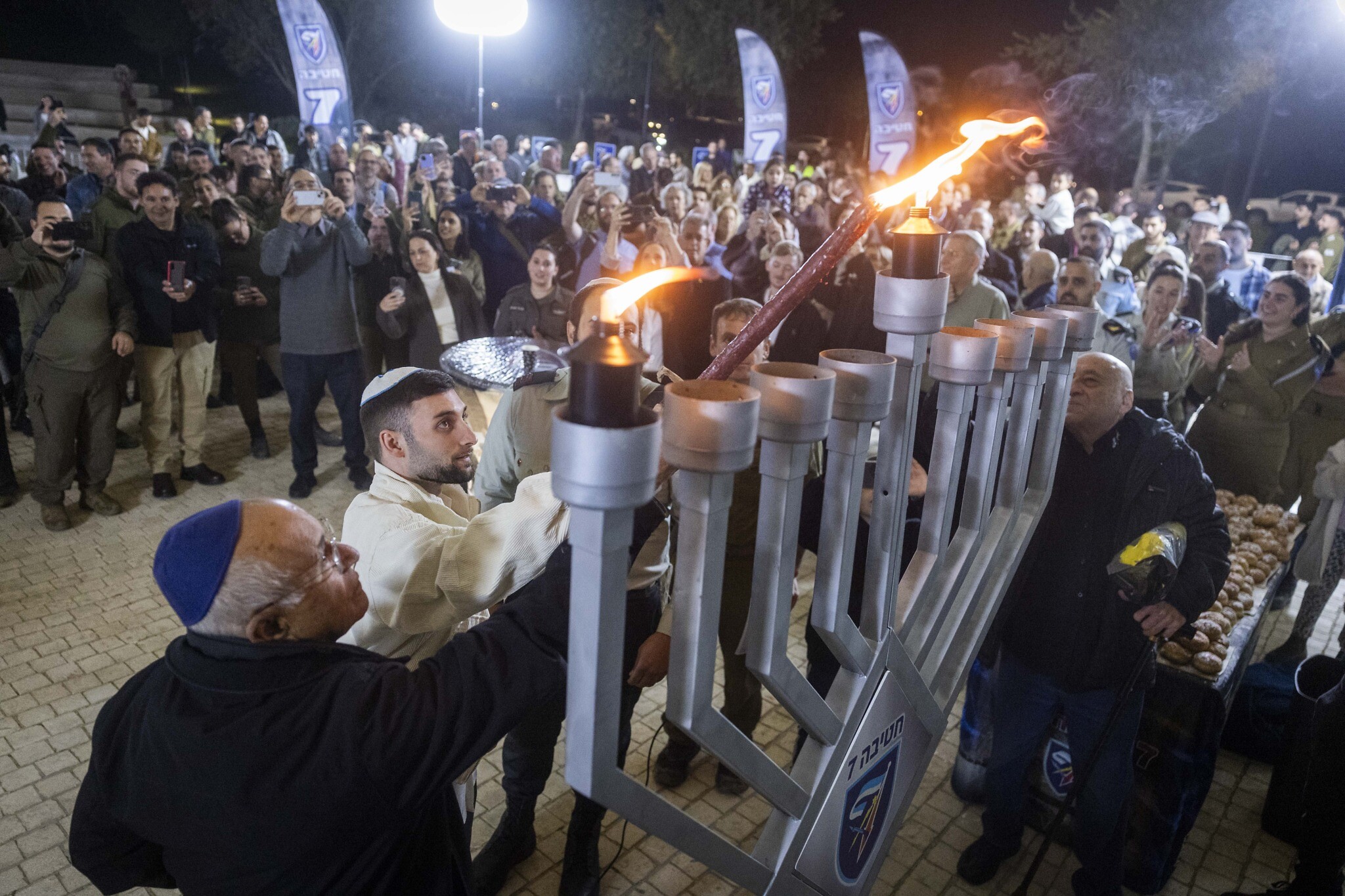 Out of darkness Freed hostages lead Hanukkah candle-lightings