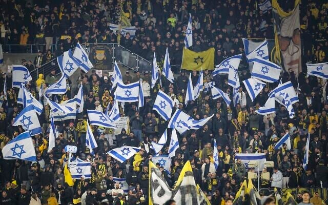 Fans of Beitar Jerusalem during an Israeli Premier League match against Bnei Sakhnin at the Teddy Stadium in Jerusalem on December 15, 2025. (Danny Maron/ Flash90) Fans of Beitar Jerusalem during an Israeli Premier League match against Bnei Sakhnin at the Teddy Stadium in Jerusalem on December 15, 2025. (Danny Maron/ Flash90)