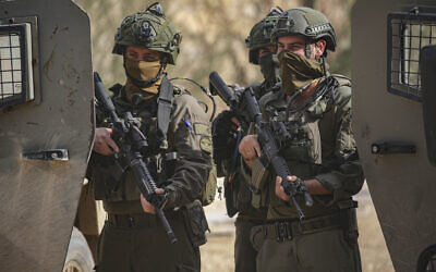 Illustrative: Israeli soldiers stand guard during a protest by Palestinians who were evacuated by the IDF from their homes in the Nur Shams refugee camp in Tulkarem, in the West Bank, on December 15, 2025. (Nasser Ishtayeh/Flash90)