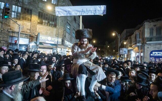 An ultra-Orthodox Jew takes part in a parade in the Mea Shearim neighborhood of Jerusalem for a Haredi draft dodger who was released from military prison, December 18, 2025. (Chaim Goldberg/Flash90) An ultra-Orthodox Jew takes part in a parade in the Mea Shearim neighborhood of Jerusalem for a Haredi draft dodger who was released from military prison, December 18, 2025. (Chaim Goldberg/Flash90)