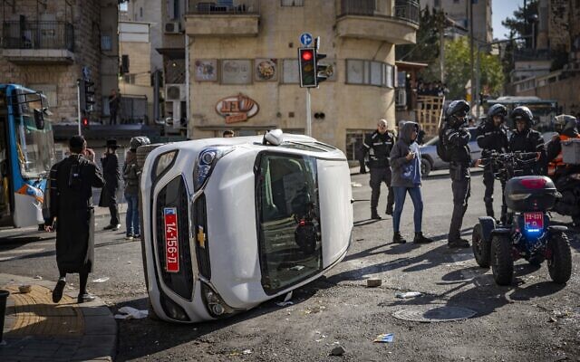 Ultra-Orthodox protesters clash with police during a protest following the issuance of a parking ticket, in Jerusalem, on December 18, 2025. (Yonatan Sindel/Flash90)