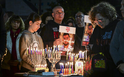 Relatives, friends and supporters of Master Sgt. Ran Gvili, whose body is held by Hamas, light Hanukkah candles at Hostages Square in Tel Aviv, December 21, 2025. (Avshalom Sassoni/Flash90)