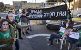 Activists calling for the establishment of a state commission of inquiry into Hamas's October 7, 2023, massacre protest outside the Prime Minister’s Office in Jerusalem, December 22, 2025. (Chaim Goldberg/Flash90)
