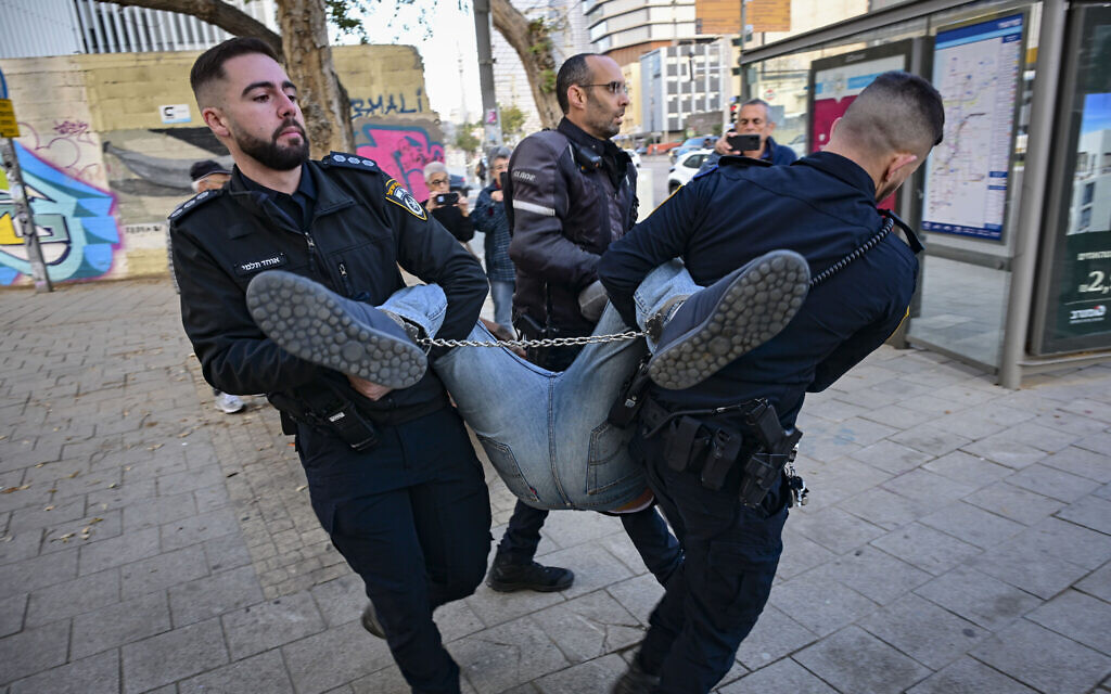 Police arrest a man during a protest calling for a state commission of inquiry into the October 7, 2023, attack, outside the home of Knesset Speaker Amir Ohana in Tel Aviv, December 24, 2025. (Avshalom Sassoni/Flash90) Police arrest a man during a protest calling for a state commission of inquiry into the October 7, 2023, attack, outside the home of Knesset Speaker Amir Ohana in Tel Aviv, December 24, 2025. (Avshalom Sassoni/Flash90)