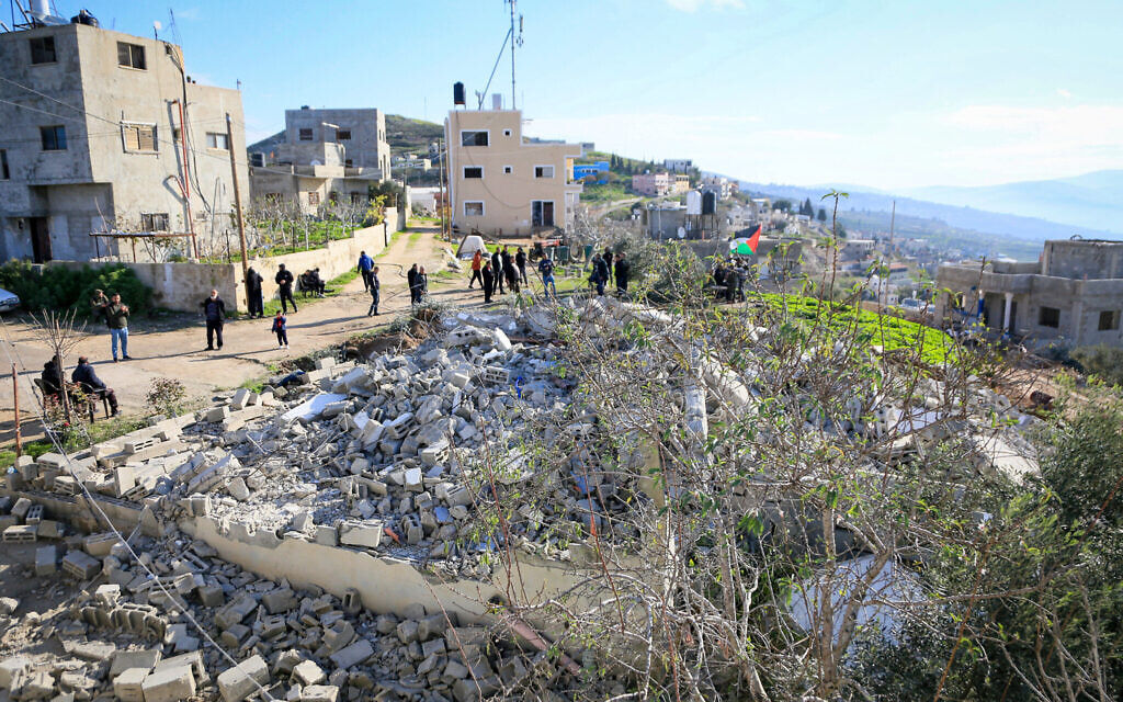 Palestinians inspect the home of a terrorist demolished by the IDF in the West Bank village of Bazariya, December 24, 2025. (Nasser Ishtayeh/Flash90) Palestinians inspect the home of a terrorist demolished by the IDF in the West Bank village of Bazariya, December 24, 2025. (Nasser Ishtayeh/Flash90)