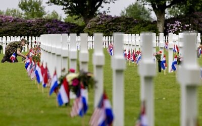 A soldier makes final preparations before the annual Memorial Day commemoration at the American cemetery in Margraten, on May 29, 2022. (Robin van Lonkhuijsen/ANP/AFP)