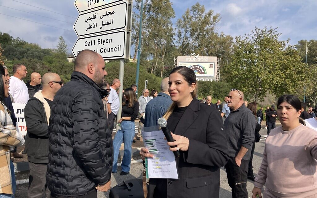Shiran Ohayon, organizer of the movement demanding services for residents in Kiryat Shmona, speaks at a protest at the entrance of the city on December 16, 2025. (Diana Bletter/Times of Israel)