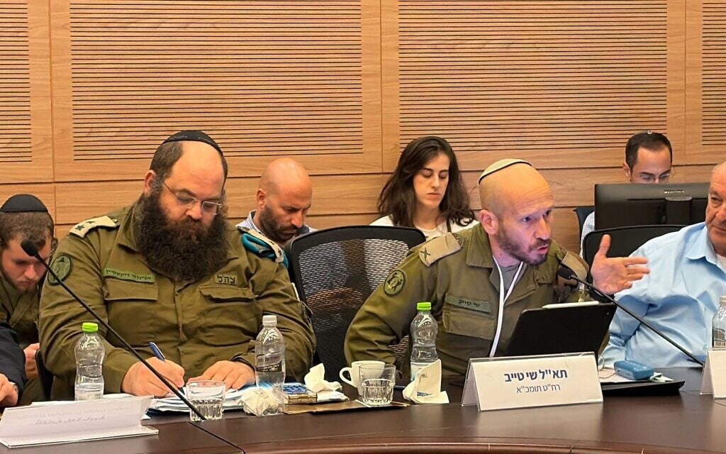 Brig. Gen. Shay Tayeb, head of the IDF Personnel Directorate's Planning and Personnel Management Division (right), speaks at a Knesset Foreign Affairs and Defense Committee meeting, December 2, 2025. (Sam Sokol/Times of Israel)