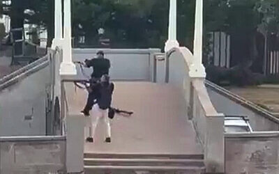 Sajid Akram, foreground, and Naveed Akram open fire in a terror attack on people at a Jewish event in Sydney, Australia, on December 14, 2025, in an image taken from a video posted online. (Screen capture: X)