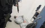 This photo sent out by an Israel Prison Service spokesperson shows terror convict Mahmoud Atallah laying on the ground after guards stormed his prison cell on December 26, 2025. (Courtesy)