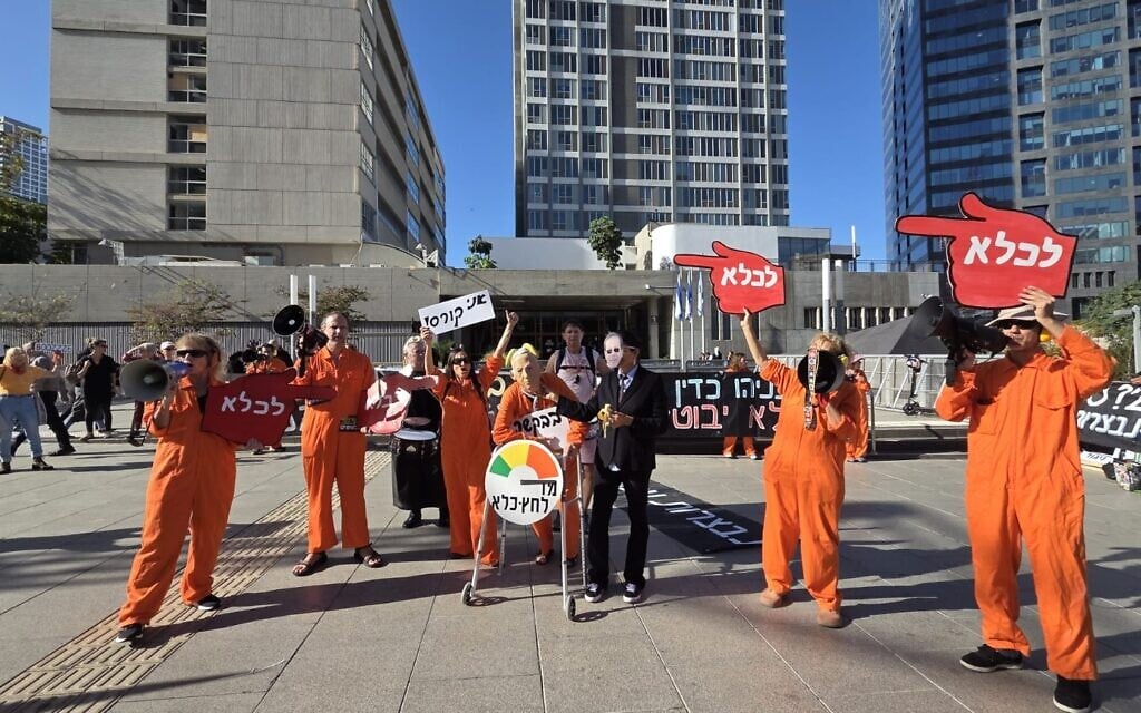 Protesters mock Prime Minister Benjamin Netanyahu's request for a pardon from President Isaac Herzog at a demonstration outside the Tel Aviv District Court, where Netanyahu is being cross-examined as part of his criminal trial, on December 1, 2025. (Efrat Safran/Pro-Democracy Protest Movement)