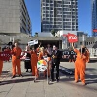 Protesters mock Prime Minister Benjamin Netanyahu's request for a pardon from President Isaac Herzog at a demonstration outside the Tel Aviv District Court, where Netanyahu is being cross-examined as part of his criminal trial, on December 1, 2025. (Efrat Safran/Pro-Democracy Protest Movement)