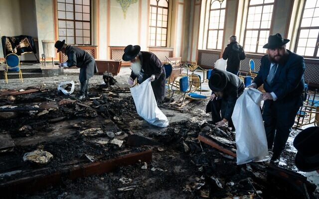 Sadigura Hasidim sift through the ashes of their synagogue, destroyed in an arson attack in November 2025 (Meir Zalaznik) Sadigura Hasidim sift through the ashes of their synagogue, destroyed in an arson attack in November 2025 (Meir Zalaznik)