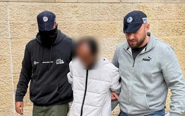 Police detain a 43-year-old resident of Mevaseret Zion suspected of killing a mother and her son days prior, before they bring him to the Nof Hagalil-Nazareth Magistrate's Court on December 12, 2025. (Israel Police) Police detain a 43-year-old resident of Mevaseret Zion suspected of killing a mother and her son days prior, before they bring him to the Nof Hagalil-Nazareth Magistrate's Court on December 12, 2025. (Israel Police)