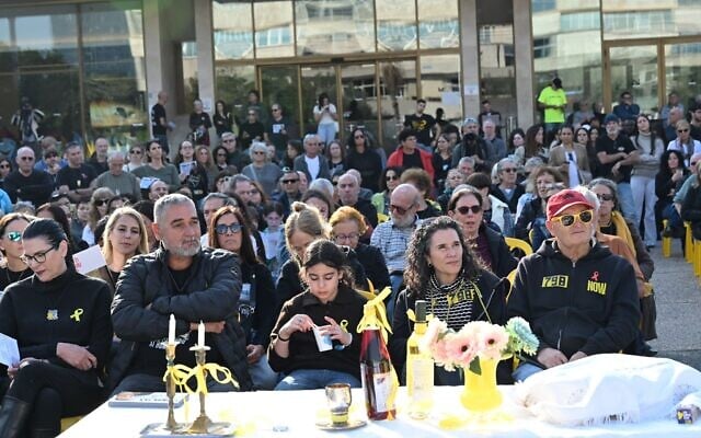 Talik Gvili (left) and Itzik Gvili (second from left), the parents of the final deceased hostage in Gaza, Ran Gvili, are joined by members of the public at a pre-Shabbat vigil at Tel Aviv's Hostages Square, on December 12, 2025. (Paulina Patimer/The Hostages and Missing Families Forum)
