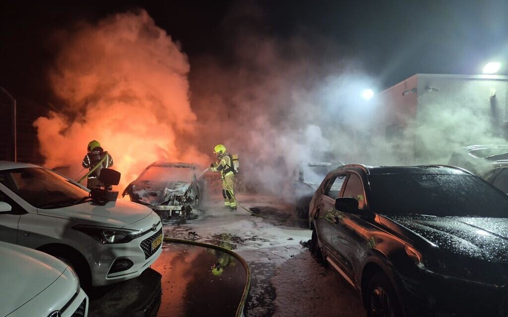 Firefighters extinguish blazes in a parking lot in Lehavim, a Jewish town in the Negev, caused by an apparent arson attack overnight on December 31, 2025. (Fire and Rescue Service)
