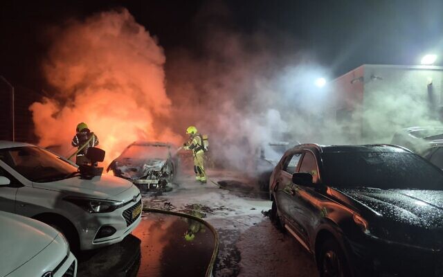Firefighters extinguish blazes in a parking lot in Lehavim, a Jewish town in the Negev, caused by an apparent arson attack overnight on December 31, 2025. (Fire and Rescue Service)