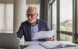 An entrepreneur checks his work calendar. (Moon Safari, at iStock by Getty Images)