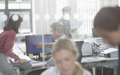 Illustrative: Employees work in an office in the UK. (Tom Merton/iStock)