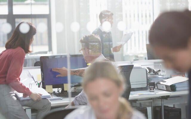 Illustrative: Employees work in an office in the UK. (Tom Merton/iStock)
