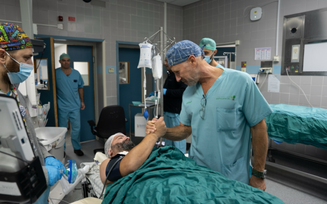 Dr. Eviatar Nesher, right, with Daniel Haim Biton at Rabin Medical Center. In an organ transplant, Biton received the small intestine of a six-year-old who died of the flu on December 3, 2025. (Courtesy Rabin Medical Center)