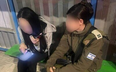 An Israeli woman who was extracted from the West Bank city of Jericho is seen next to an officer from the Civil Administration, December 19, 2025. (Courtesy)