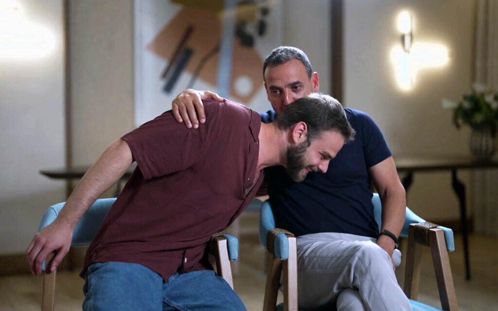Alon Ohel (L) and Eli Sharabi (R) hug during an interview that aired December 4, 2025. (Screenshot via Channel 12) Alon Ohel (L) and Eli Sharabi (R) hug during an interview that aired December 4, 2025. (Screenshot via Channel 12)