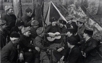 Illustrative: A group of Soviet partisans singing during a lull in the fighting. (Photographed by Yakov Davidson. Ghetto Fighters’ House Museum, Israel/Photo Archive)