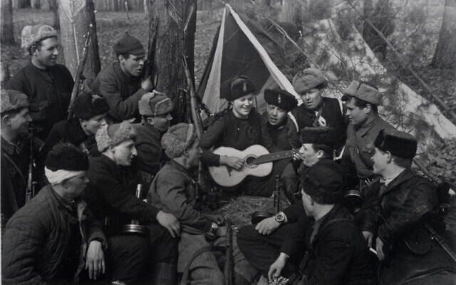 Illustrative: A group of Soviet partisans singing during a lull in the fighting. (Photographed by Yakov Davidson. Ghetto Fighters’ House Museum, Israel/Photo Archive)
