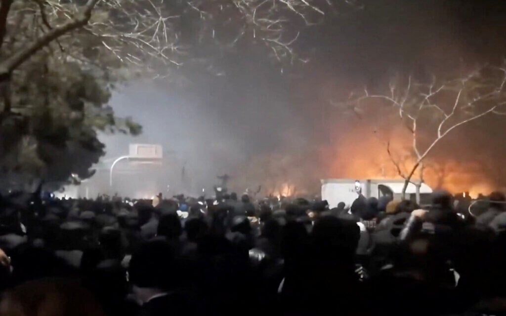 Smoke rises as protesters gather amid evolving anti-government unrest at Vakilabad highway in Mashhad, Razavi Khorasan province, Iran, January 10, 2026, in this screen grab obtained from a social media video. (SOCIAL MEDIA/via REUTERS)