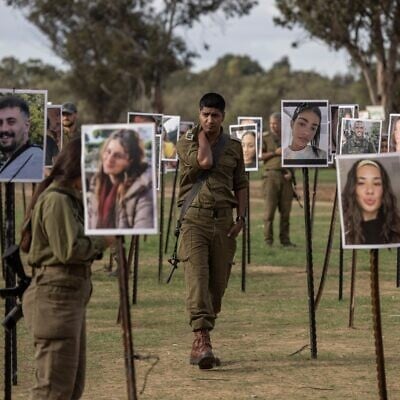 IDF soldiers at the emerging memorial for those killed at the Nova rave on October 7, 2023 (Avishag Shaar-Yashuv) IDF soldiers at the emerging memorial for those killed at the Nova rave on October 7, 2023 (Avishag Shaar-Yashuv)