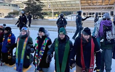 A line of interfaith leaders protest Immigrations and Customs Enforcement at the Minneapolis-St. Paul airport, Jan. 23, 2026. Rabbi Emma Kippley-Ogman was arrested and briefly detained during the demonstration. (Courtesy of Rabbi Aaron Weininger via JTA)