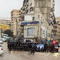 Police officers pose for a group photo in the Palestinian refugee camp of Shuafat, east of Jerusalem, January 14, 2026. (Used in accordance with Clause 27a of the Copyright Law)