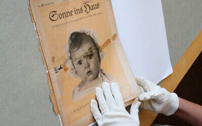 At the archives of the Yad Vashem Holocaust memorial museum, the front page of the original issue of the Nazi family magazine "Sonnie ins Hous" (Sunshine in the House) shows baby Hessy Levinsons Taft as the ideal German Aryan baby, part of Nazi propaganda of Joseph Goebbels on July 8, 2014 after it was recently donated by her to the museum. (GALI TIBBON / AFP)