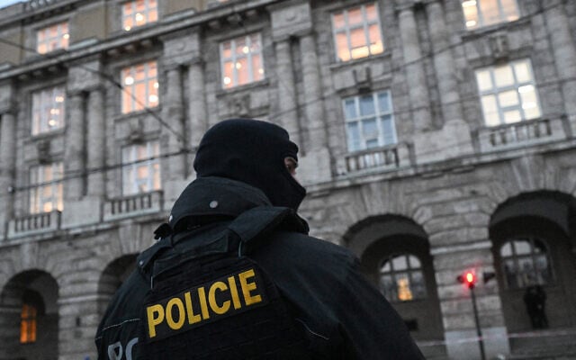 Illustrative: A police officer is seen in front of the Charles University in central Prague, on December 22, 2023. (Michal Cizek / AFP) Illustrative: A police officer is seen in front of the Charles University in central Prague, on December 22, 2023. (Michal Cizek / AFP)