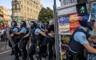 Portuguese police detain a woman who was protesting against a demonstration against 'uncontrolled immigration' called by Portuguese far-right party Chega in Lisbon on September 29, 2024. (Patricia De Melo Moreira/AFP) Portuguese police detain a woman who was protesting against a demonstration against 'uncontrolled immigration' called by Portuguese far-right party Chega in Lisbon on September 29, 2024. (Patricia De Melo Moreira/AFP)
