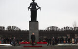 In this pool photograph distributed by the Russian state agency Sputnik, Russia's President Vladimir Putin attends a wreath-laying ceremony at the monument 'Motherland' at the Piskaryovskoye Memorial Cemetery in Saint Petersburg, on January 27, 2025, marking the 81st anniversary of the liberation of Leningrad from Nazi blockade in World War Two (Vyacheslav Prokofyev/Pool/ AFP)