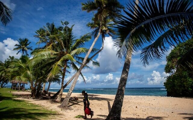 This picture taken on March 23, 2025, shows a resident walking along the Vavau Beach in Samoa on an autumn morning (Manaui FAULALO / AFP) This picture taken on March 23, 2025, shows a resident walking along the Vavau Beach in Samoa on an autumn morning (Manaui FAULALO / AFP)
