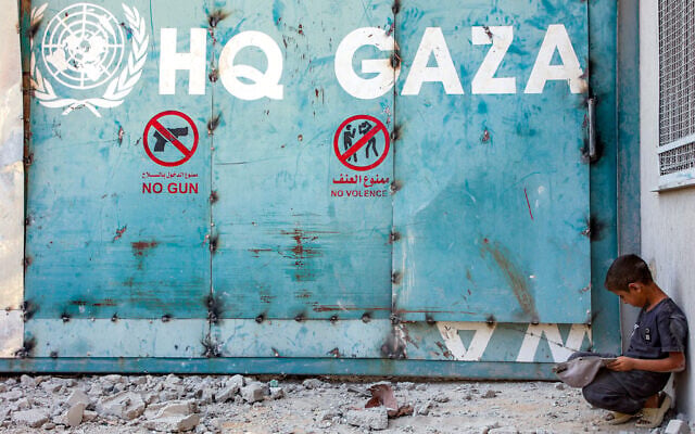 A boy sits outside the entrance to the United Nations Relief and Works Agency for Palestine Refugees (UNRWA) building complex in Gaza City on September 6, 2025. (Omar AL-QATTAA / AFP) A boy sits outside the entrance to the United Nations Relief and Works Agency for Palestine Refugees (UNRWA) building complex in Gaza City on September 6, 2025. (Omar AL-QATTAA / AFP)