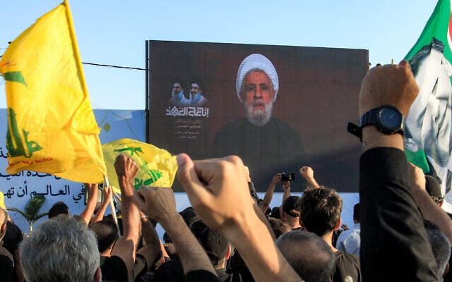 Hezbollah chief Naim Qassem, current leader of the Lebanese Shiite movement Hezbollah, addresses mourners through a screen in a televised address during a ceremony marking the first anniversary of Israel's assassination of the group's longtime leader Hassan Nasrallah and other group leaders, in the town of Deir Qanoun al-Nahr near Tyre in southern Lebanon on September 27, 2025. (Mahmoud ZAYYAT / AFP) Hezbollah chief Naim Qassem, current leader of the Lebanese Shiite movement Hezbollah, addresses mourners through a screen in a televised address during a ceremony marking the first anniversary of Israel's assassination of the group's longtime leader Hassan Nasrallah and other group leaders, in the town of Deir Qanoun al-Nahr near Tyre in southern Lebanon on September 27, 2025. (Mahmoud ZAYYAT / AFP)