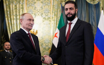 Russian President Vladimir Putin and Syrian interim president Ahmed al-Sharaa shake hands during their meeting at the Grand Kremlin Palace in Moscow on October 15, 2025. (Alexander Zemlianichenko / POOL / AFP)